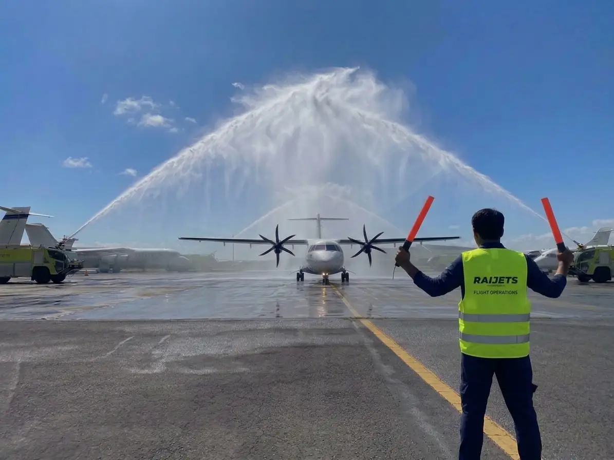 Supervision team beside a turboprop aircraft reviewing flight documents